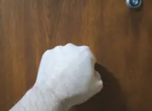 Mężczyzna pukający do drzwi mieszkania. Fot. Warszawa w Pigułce